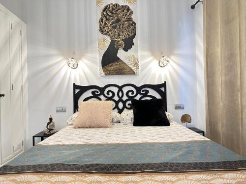 a bedroom with a black and white bed with two pillows at PLAYMAR Maspalomas Bungalow 124 Bali Style with terrace in Maspalomas