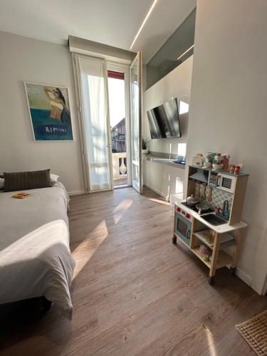 a bedroom with a bed and a table with a television at Suite Apartments - Corso51 in Rimini