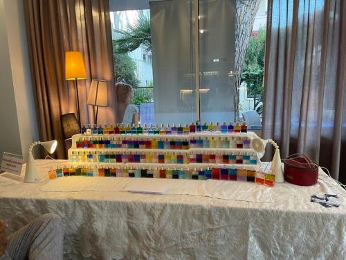 a table with many colored bottles on top of it at Aura Living Hotel in Rimini