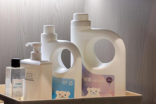a shelf with two bottles of detergent and a detergent at Atour Hotel Yinchuan Lijing Lake Jiefang Road in Yinchuan