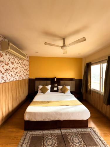 a bedroom with a large bed with a ceiling at Hotel Royal Palm - A Budget Hotel in Udaipur in Udaipur
