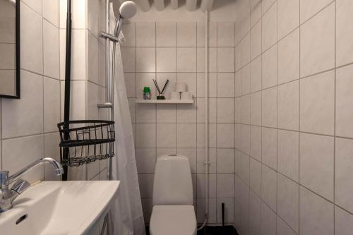 a white bathroom with a toilet and a sink at 2 BR Apartment in Heart of Vesterbro in Copenhagen