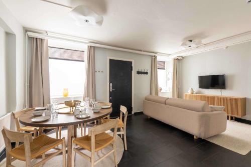 a living room with a table and a couch at 2 BR Apartment in Heart of Vesterbro in Copenhagen