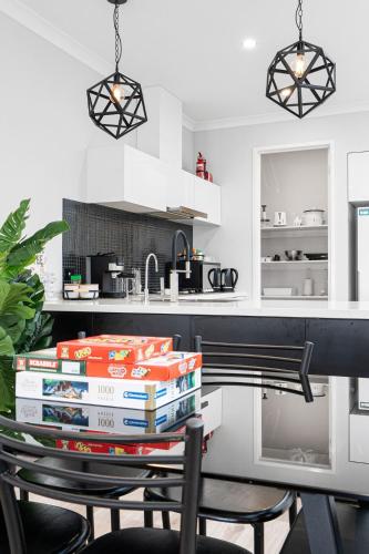 a stack of books on a table in a kitchen at Peaceful gem near Town Centre in Point Cook