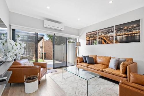 a living room with a couch and a glass table at Peaceful gem near Town Centre in Point Cook