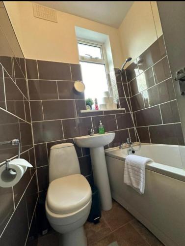 a bathroom with a toilet and a sink and a tub at Chanterlands House in Hull