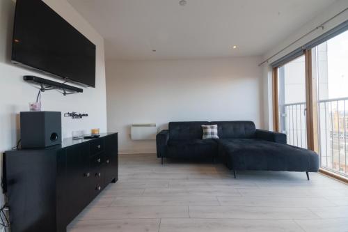 a living room with a couch and a flat screen tv at Argyle Place in Glasgow