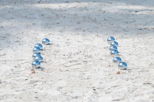 a group of blue rocks in the sand on the beach at Royal Mandarin Hotel & Resort in Pwani Mchangani