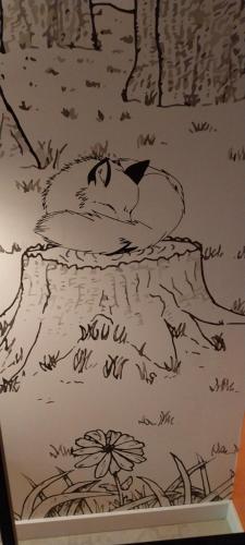a drawing of a cat laying on a bed at Les Gîtes de la Billebaude - Gîte du Renard in Eckwersheim