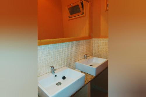 a bathroom with a white sink and a mirror at Kasbah Alami in Kalaat MGouna