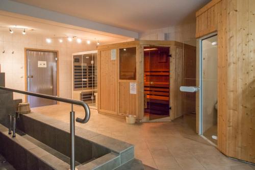 a wine cellar with wooden cabinets and a sink in a room at Landhotel Rittersgrün in Breitenbrunn