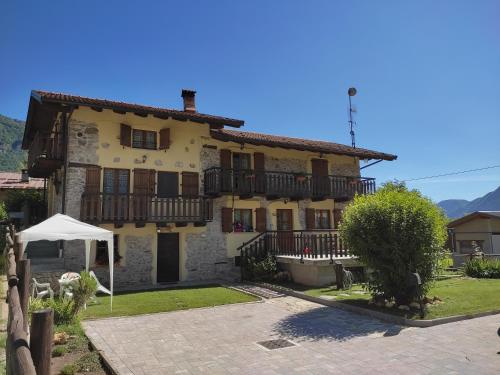 a large house with a fence in front of it at Casa Nicole Valle Stura in Demonte