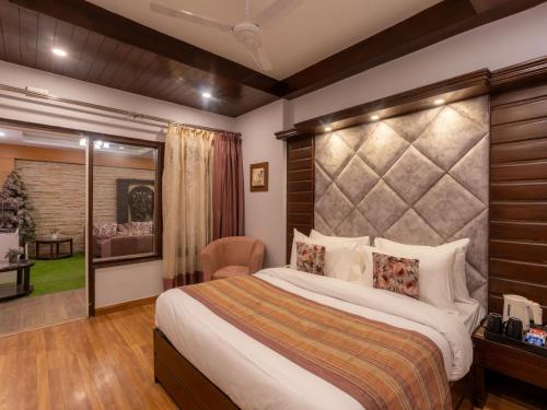 a bedroom with a large bed in a room at Moustache Mussoorie in Mussoorie