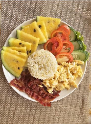 a plate of breakfast food with eggs and vegetables at Lio Palm Villas in Langi-langiban