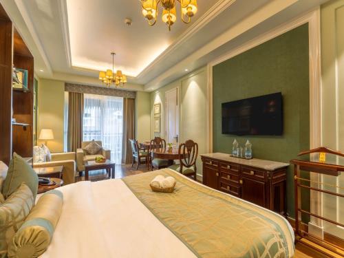 a bedroom with a bed and a living room at Moustache Mussoorie in Mussoorie