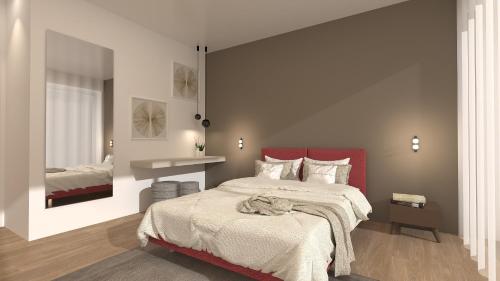 a bedroom with a large bed with a red headboard at Jesolo Design Apartments - NEW 2025 - Central near the beach in Lido di Jesolo