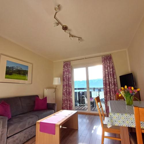 a living room with a couch and a table at Hölbinger Alm - Apartments in Anger