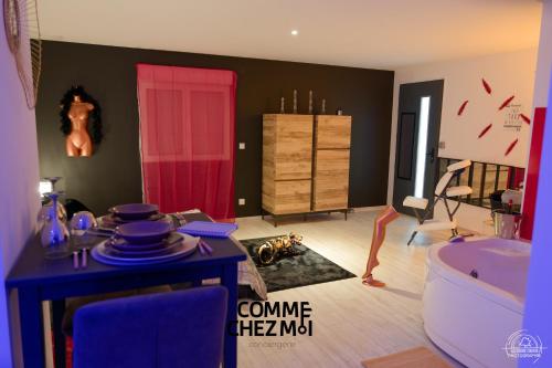 La salle de bains est pourvue d'une porte rouge et d'une baignoire. dans l'établissement Suite Loveroom, Les Folies Douces & Spa, à Nancy