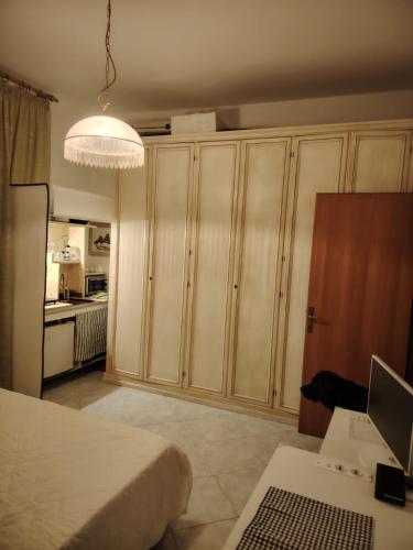 a bedroom with a bed and a desk with a computer at Cavo Beach 5 in Cavo