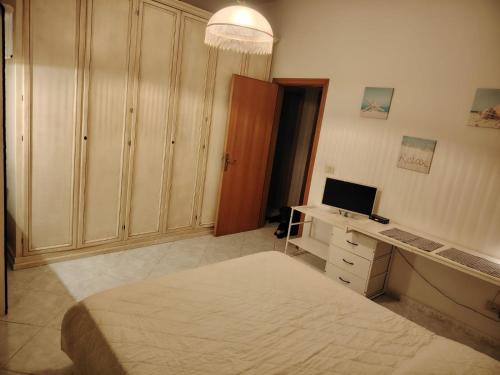 a bedroom with a bed and a desk with a computer at Cavo Beach 5 in Cavo