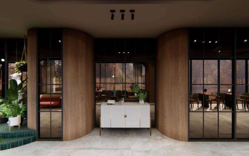 a lobby with a desk in a building with windows at Gift City Club, a member of Radisson Individuals in Gandhinagar