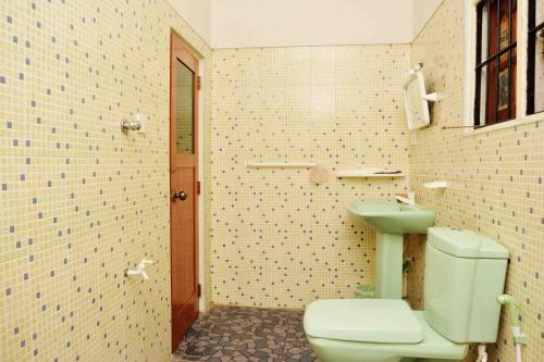 a bathroom with a toilet and a sink at Sampathaa Residence in Negombo