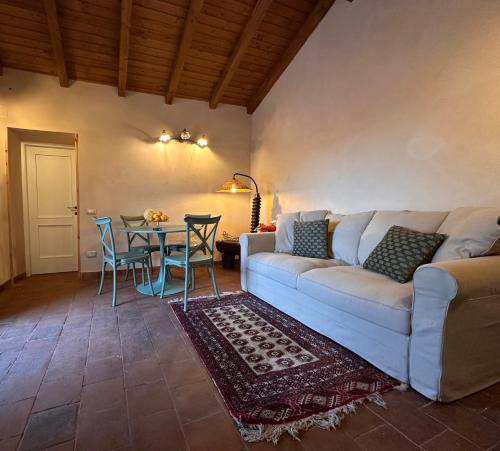 a living room with a couch and a table at La Casetta di Lollò in Aci SantʼAntonio