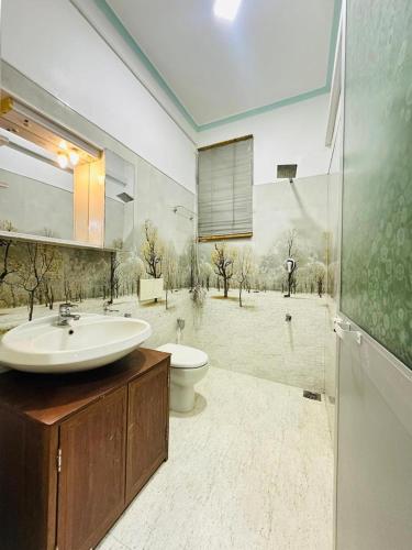 a bathroom with a sink and a toilet at Millennium Luxury Apartments in Negombo