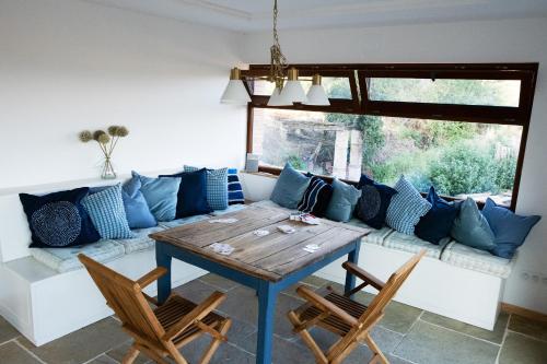 a living room with a couch and a table and chairs at Gîte de Rossignol in Cabanac-Séguenville