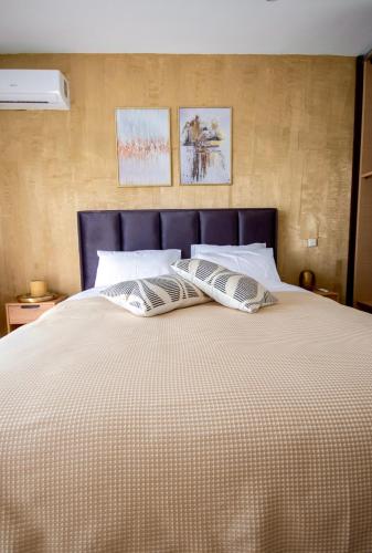 a large bed with two pillows on top of it at LUXE COASTAL RETREAT Apartment in Alexandroupoli