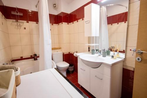 a bathroom with a sink and a toilet and a tub at LUXE COASTAL RETREAT Apartment in Alexandroupoli