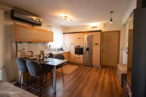 a kitchen with a table and chairs in a room at LUXE COASTAL RETREAT Apartment in Alexandroupoli