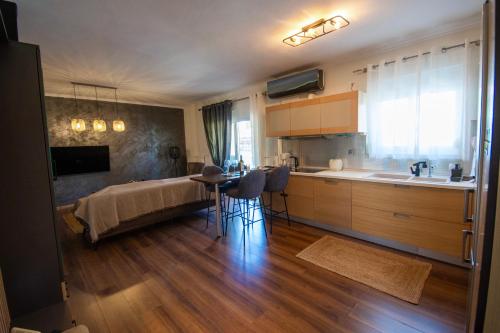 a kitchen with a bed and a table in a room at LUXE COASTAL RETREAT Apartment in Alexandroupoli