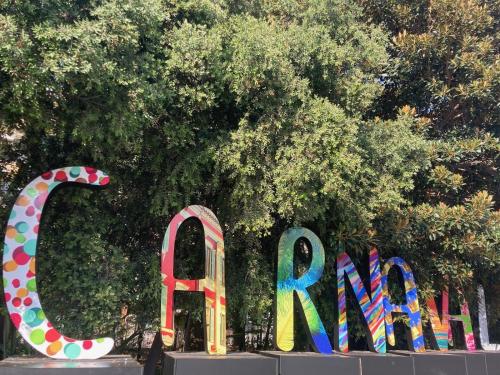 a group of colorful signs in front of a tree at Wunderschöne Wohnung in Jugendstilvilla am Hafen in Nice