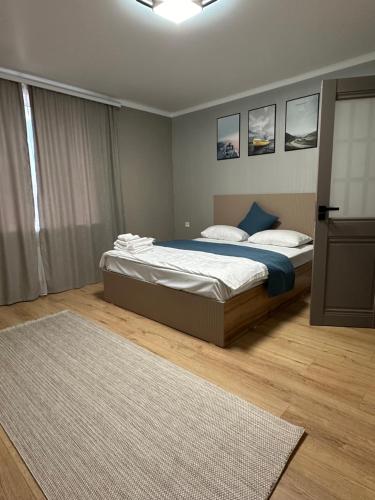a bedroom with a bed and a rug at Aish hotel in Karagandy