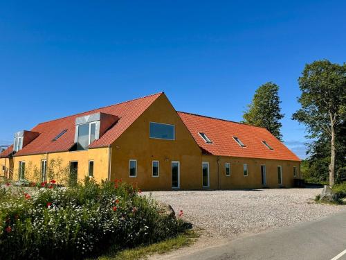 a large building with red roofs on a road at Large holiday apartment in Ebeltoft