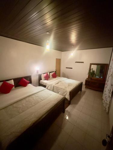 a bedroom with two beds in a room at ABC Guest Inn & Restaurant in Haputale