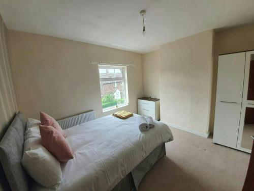 a bedroom with a bed and a window at Beautiful House in Stoke in Audley