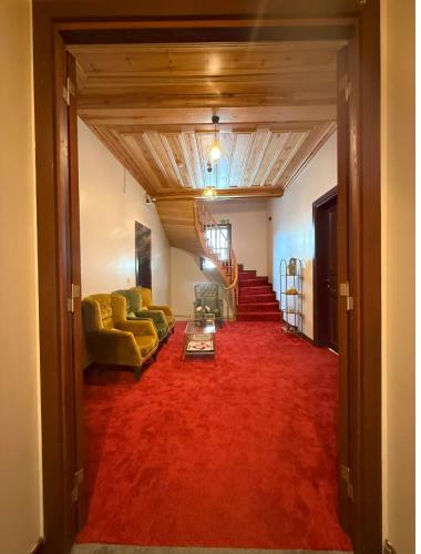 a living room with a couch and a red carpet at Grand Bedir in Istanbul