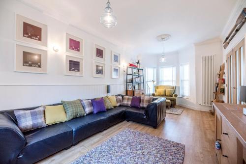 a living room with a blue couch and a table at Cosy Nook, Southwold in Southwold