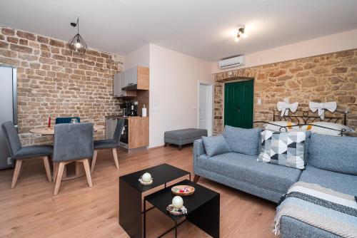 a living room with a couch and a table at Sizgoric Palace Suites Sibenik in Šibenik