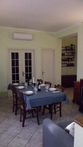 a dining room with a table with a blue table cloth at La casetta rossa in Collicello