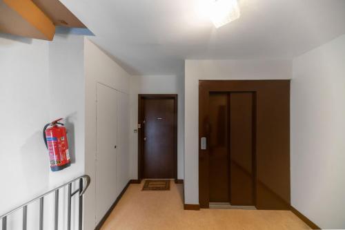 an empty hallway with a fire extinguisher on the wall at L'Alquié - Appartement design hyper centre in Vichy