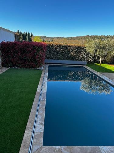 a swimming pool in a yard with green grass at La Maison d AME - for the perfect stay at the Mont Ventoux in Malaucène