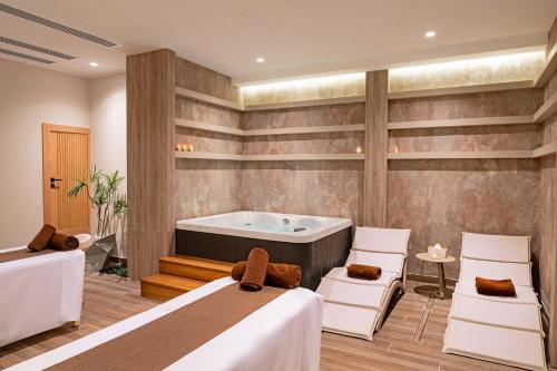 a room with two beds and a bath tub at Sentido Naga Bay - Adults friendly in Hurghada