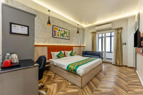 a hotel room with a bed and a desk at Treebo Divine Stay Prayagraj in Prayagraj