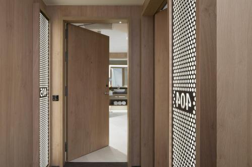a hallway with a door leading into a room at ME Barcelona in Barcelona