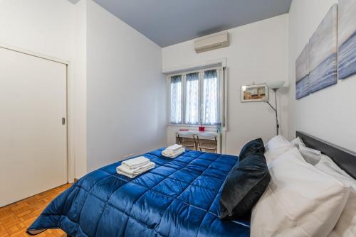 a bedroom with a large blue bed with pillows at Milano Centro Duomo-Wifi-Metro in Milan