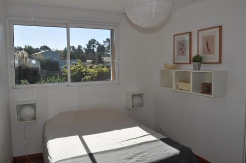 une chambre blanche avec un lit et une fenêtre dans l'établissement Villa Ita 6 to 8 berths - Private pool, à Moliets-et-Maa