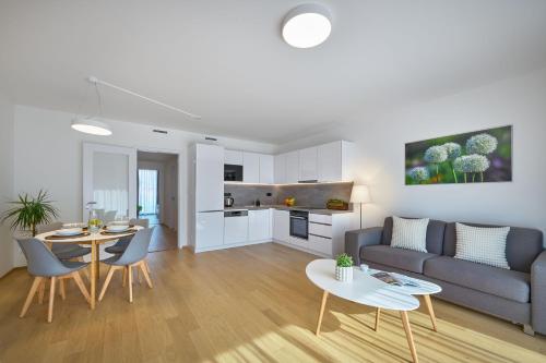 a living room with a couch and a table at DownTown Suites Andel in Prague